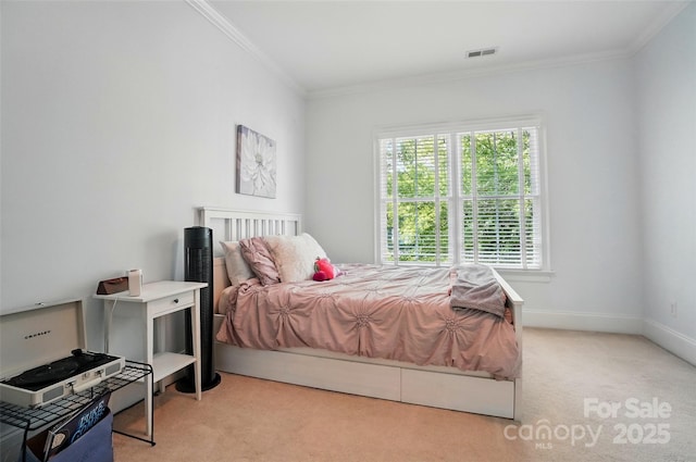 bedroom featuring carpet floors, ornamental molding, baseboards, and visible vents