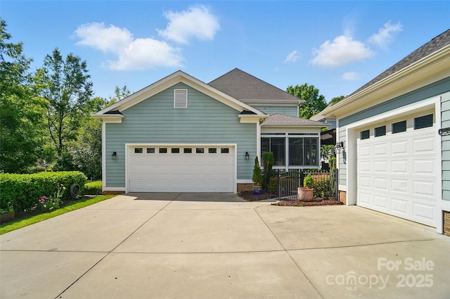 view of front of home featuring a sunroom and driveway