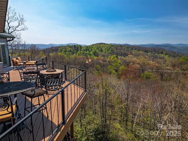 balcony with a deck with mountain view and a wooded view