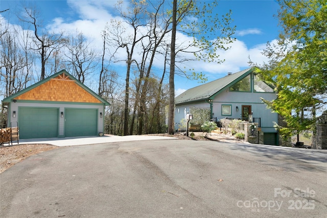 view of side of home featuring an outdoor structure and a garage
