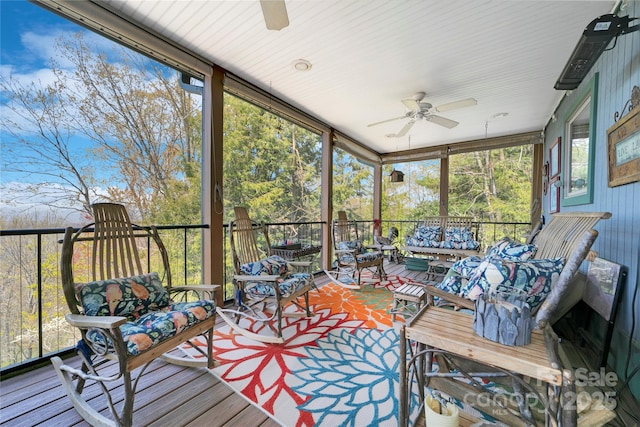 sunroom / solarium with an outdoor living space and a ceiling fan