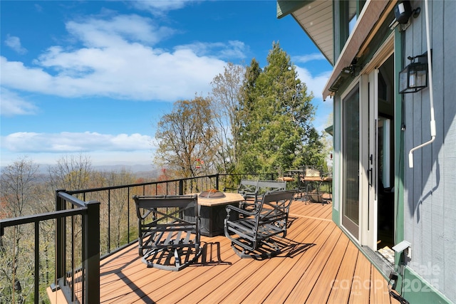 deck featuring an outdoor fire pit