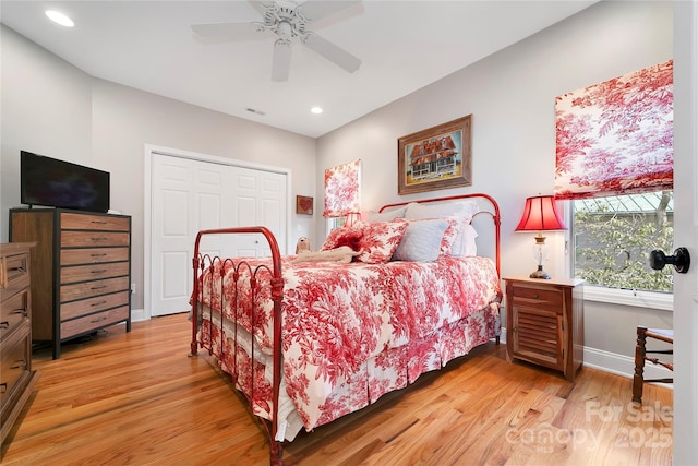 bedroom with light wood-style floors, recessed lighting, baseboards, and a closet
