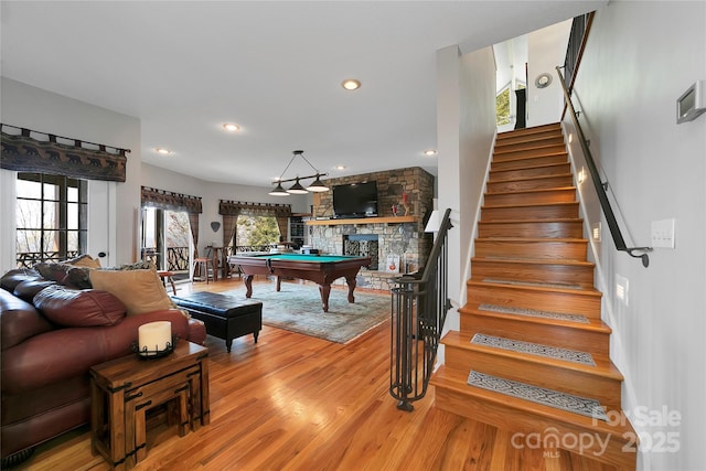 game room featuring recessed lighting, pool table, light wood finished floors, and a fireplace