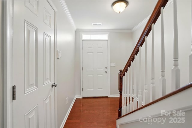 foyer with stairway, baseboards, and ornamental molding
