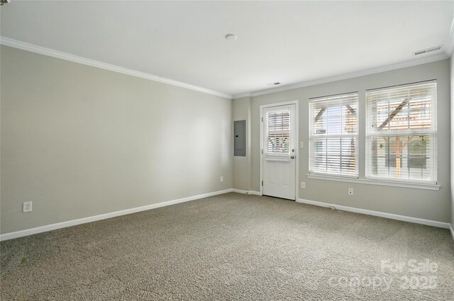 unfurnished room with electric panel, baseboards, visible vents, carpet, and ornamental molding