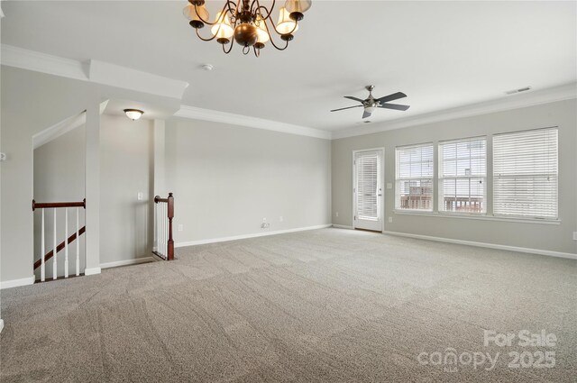 carpeted spare room with visible vents, baseboards, ornamental molding, and ceiling fan with notable chandelier