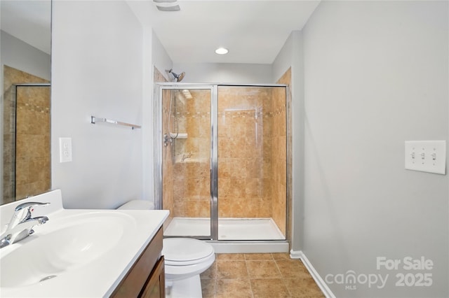 full bath with tile patterned floors, toilet, a stall shower, baseboards, and vanity