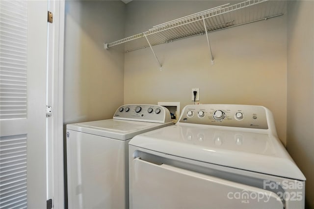 washroom with washing machine and dryer and laundry area