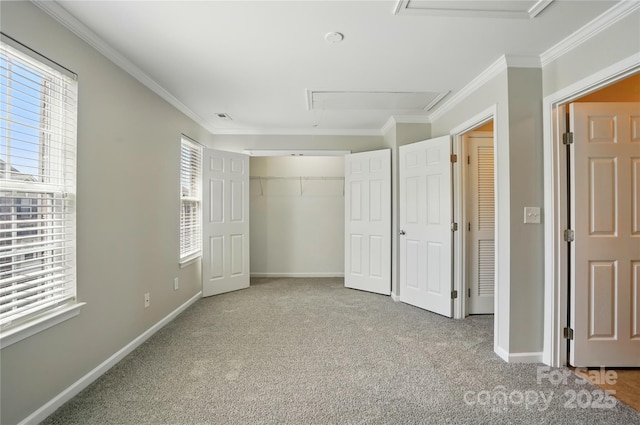 unfurnished bedroom featuring attic access, baseboards, and carpet