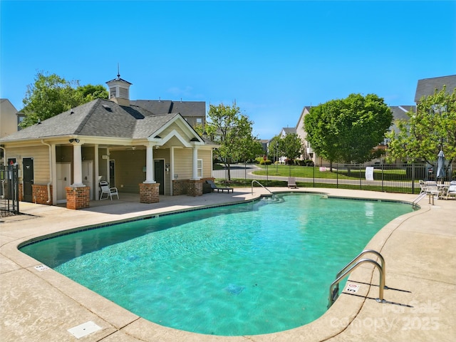 pool with fence and a patio