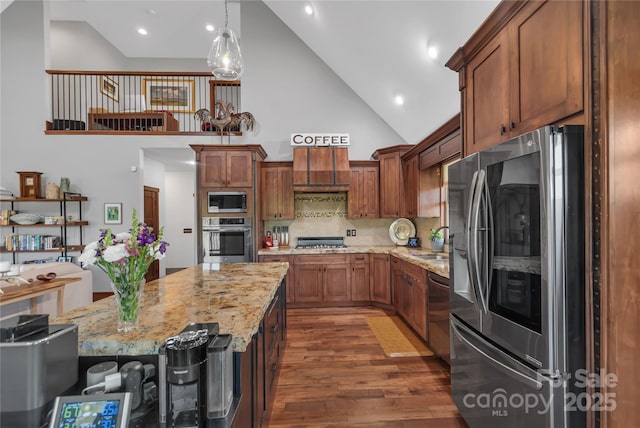 334 Willow Top Ln, Lake Lure, NC 28746 - kitchen featuring appliances with stainless steel finishes, high vaulted ceiling, custom range hood, dark wood-type flooring, and light stone countertops