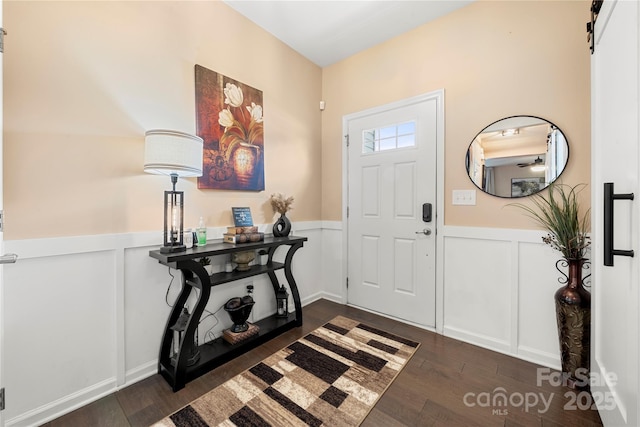 2262 Galloway Ln SW, Concord, NC 28025 - entryway with wainscoting, dark wood-style floors, and a decorative wall