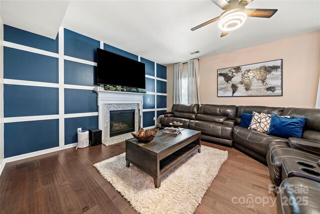 2262 Galloway Ln SW, Concord, NC 28025 - living area featuring visible vents, built in shelves, wood finished floors, ceiling fan, and a tile fireplace