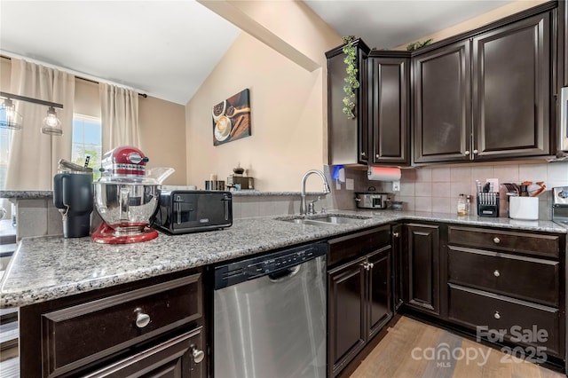 2262 Galloway Ln SW, Concord, NC 28025 - kitchen featuring lofted ceiling, stainless steel appliances, a sink, and light stone counters