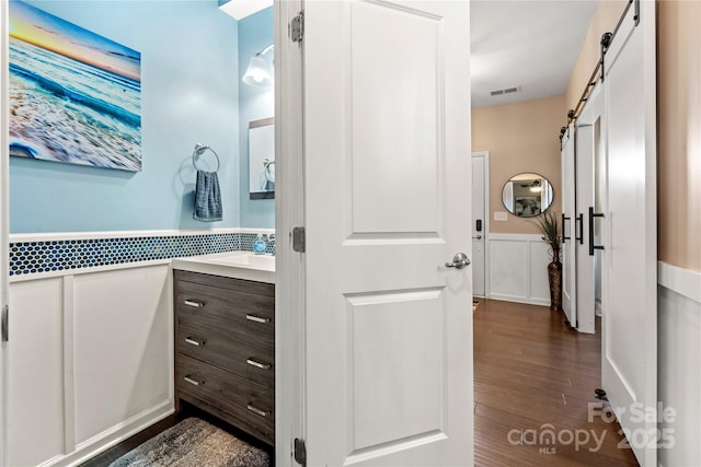 2262 Galloway Ln SW, Concord, NC 28025 - bathroom with wood finished floors, visible vents, and vanity