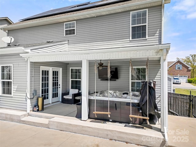 2262 Galloway Ln SW, Concord, NC 28025 - rear view of house with fence, a hot tub, ceiling fan, roof mounted solar panels, and a patio
