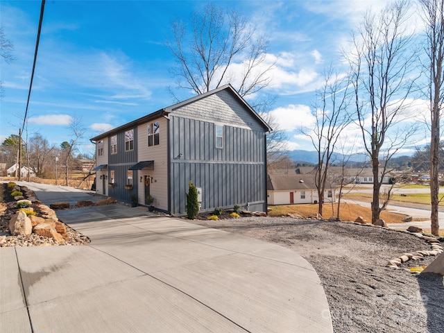 282 County Rd, Waynesville, NC 28785 - view of property exterior featuring board and batten siding and concrete driveway
