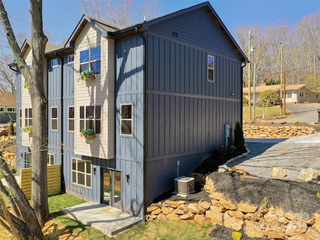 282 County Rd, Waynesville, NC 28785 - view of property exterior with board and batten siding, french doors, and cooling unit