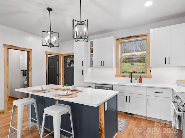 282 County Rd, Waynesville, NC 28785 - kitchen with open shelves, a chandelier, a center island, a sink, and stainless steel appliances