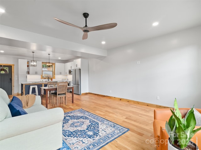 282 County Rd, Waynesville, NC 28785 - living room featuring light wood-style flooring, baseboards, and ceiling fan