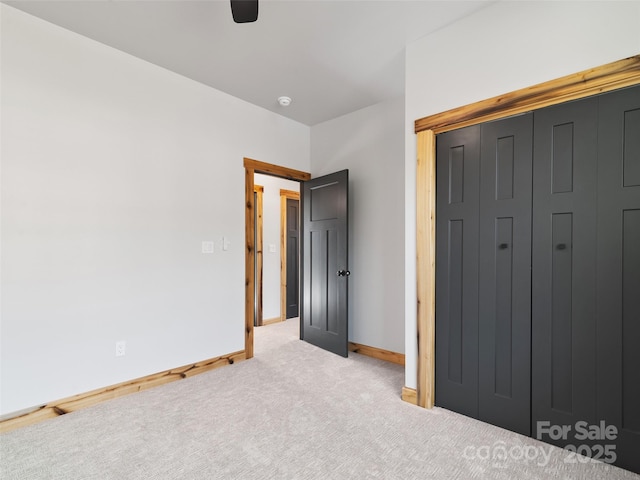 282 County Rd, Waynesville, NC 28785 - unfurnished bedroom featuring ceiling fan, a closet, carpet flooring, and baseboards