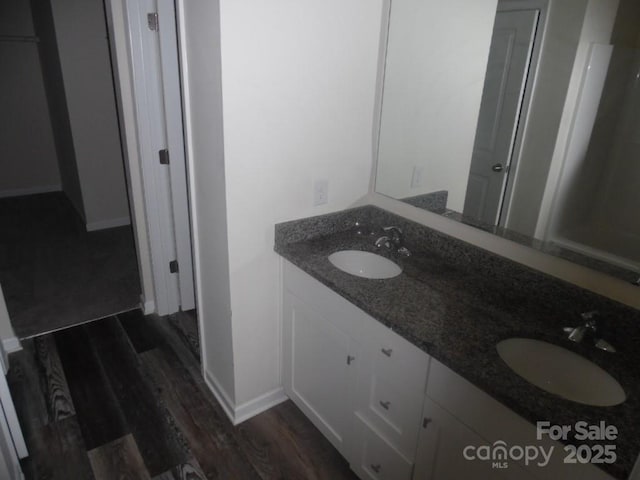 574 30th Avenue Cir NE, Hickory, NC 28601 - full bathroom featuring a sink, baseboards, double vanity, and wood finished floors