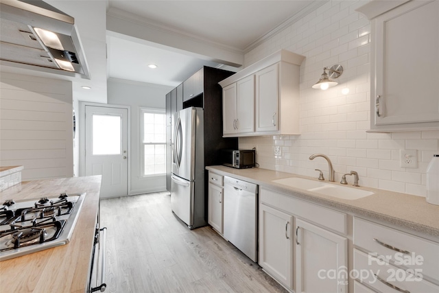 5901 Quail Hollow Rd Unit G, Charlotte, NC 28210 - kitchen featuring stainless steel appliances, a sink, ornamental molding, light countertops, and backsplash
