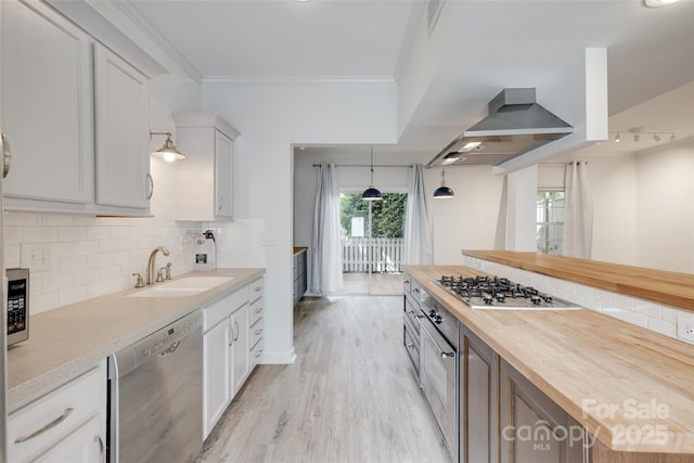 5901 Quail Hollow Rd Unit G, Charlotte, NC 28210 - kitchen with appliances with stainless steel finishes, wooden counters, a sink, wall chimney exhaust hood, and decorative backsplash