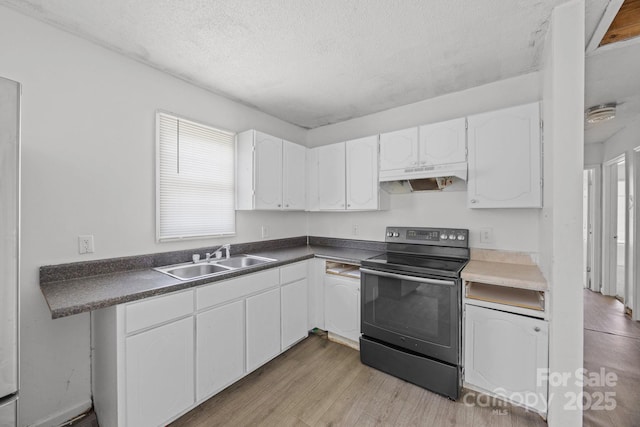 809 1st St E, Ahoskie, NC 27910 - kitchen with black electric range oven, a sink, white cabinets, a textured ceiling, and dark countertops