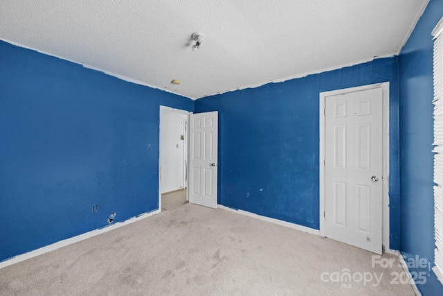 809 1st St E, Ahoskie, NC 27910 - unfurnished bedroom with carpet, baseboards, and a textured ceiling