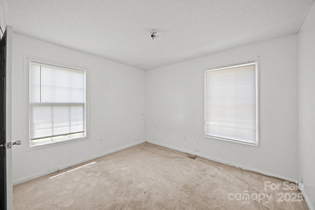 809 1st St E, Ahoskie, NC 27910 - unfurnished room with carpet flooring, a textured ceiling, and baseboards