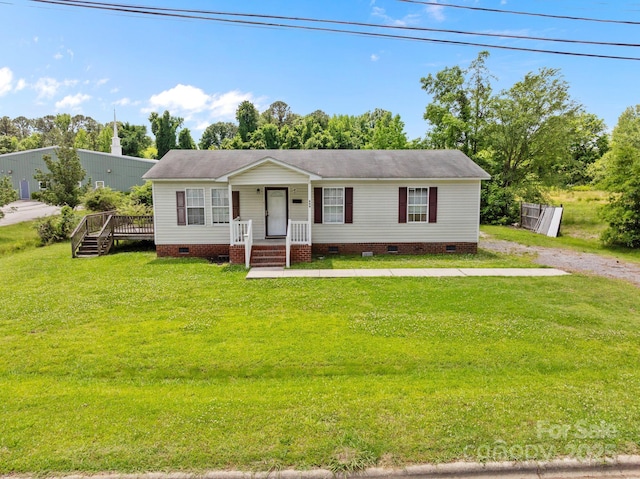 809 1st St E, Ahoskie, NC 27910 - view of front facade with crawl space, a front yard, a deck, and a shingled roof