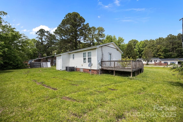 809 1st St E, Ahoskie, NC 27910 - back of house featuring central AC unit, a wooden deck, and a lawn
