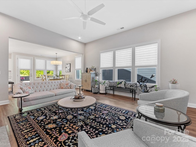 living area with visible vents, wood finished floors, and a wealth of natural light
