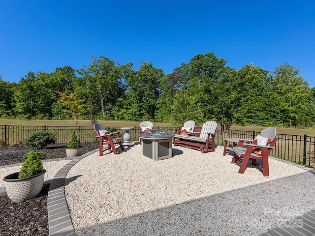 view of patio / terrace with an outdoor fire pit and fence