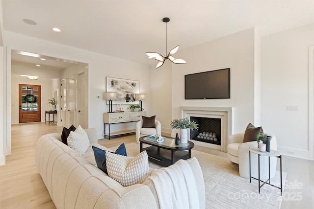 3473 Willow Oak Rd, Charlotte, NC 28209 - living room with an inviting chandelier, recessed lighting, baseboards, and light wood-type flooring