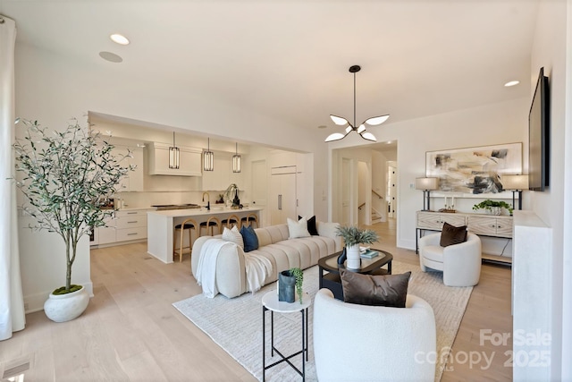 3473 Willow Oak Rd, Charlotte, NC 28209 - living area with recessed lighting, light wood-type flooring, stairs, and a chandelier