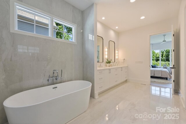 3473 Willow Oak Rd, Charlotte, NC 28209 - ensuite bathroom featuring ceiling fan, a freestanding bath, ensuite bath, vanity, and marble finish floor