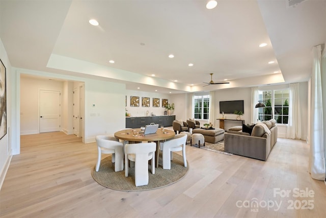 3473 Willow Oak Rd, Charlotte, NC 28209 - dining room with a ceiling fan, a raised ceiling, baseboards, recessed lighting, and light wood-style flooring