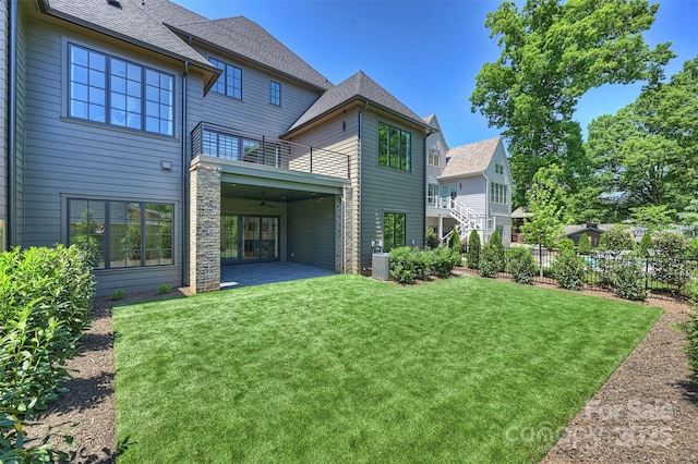 3473 Willow Oak Rd, Charlotte, NC 28209 - back of house with fence, a balcony, a patio, a ceiling fan, and a lawn