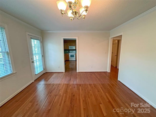 904 3rd Street Pl NE, Conover, NC 28613 - spare room with an inviting chandelier, crown molding, and wood finished floors