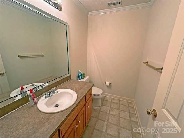 904 3rd Street Pl NE, Conover, NC 28613 - bathroom with visible vents, ornamental molding, vanity, toilet, and a textured ceiling