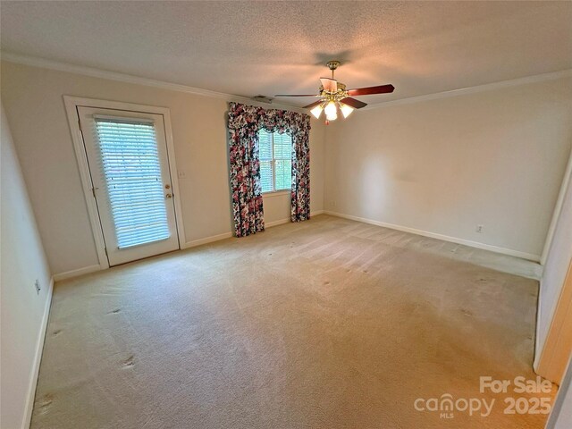 904 3rd Street Pl NE, Conover, NC 28613 - carpeted spare room featuring ceiling fan, a textured ceiling, visible vents, crown molding, and baseboards