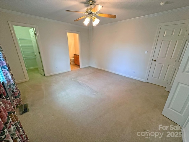 904 3rd Street Pl NE, Conover, NC 28613 - unfurnished bedroom with crown molding, light carpet, baseboards, ensuite bathroom, and a ceiling fan