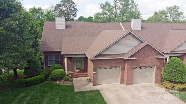 904 3rd Street Pl NE, Conover, NC 28613 - view of front of home with concrete driveway, brick siding, a chimney, and roof with shingles
