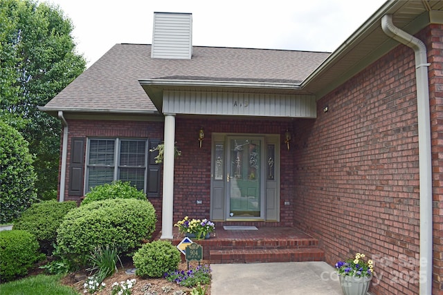 904 3rd Street Pl NE, Conover, NC 28613 - entrance to property featuring a shingled roof, a chimney, and brick siding