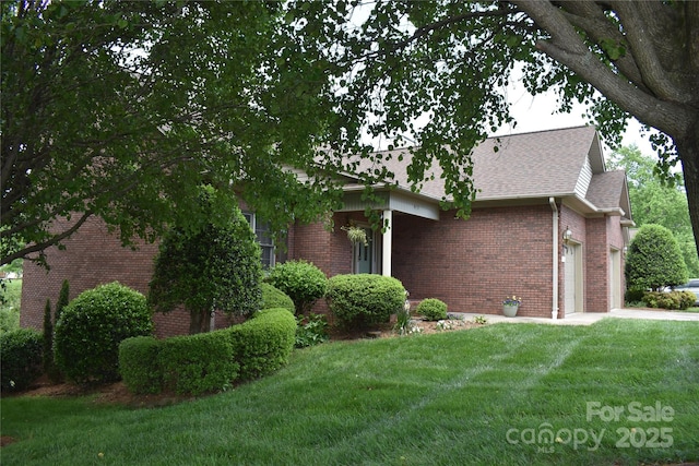 904 3rd Street Pl NE, Conover, NC 28613 - view of side of property with an attached garage, a shingled roof, a yard, and brick siding