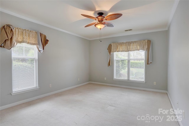 unfurnished room with carpet flooring, visible vents, baseboards, ceiling fan, and ornamental molding