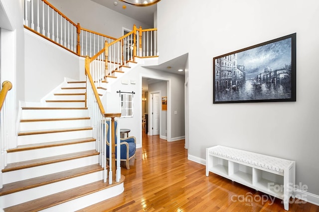 16532 Flintrock Falls Ln, Charlotte, NC 28278 - stairs with baseboards, wood finished floors, and a high ceiling